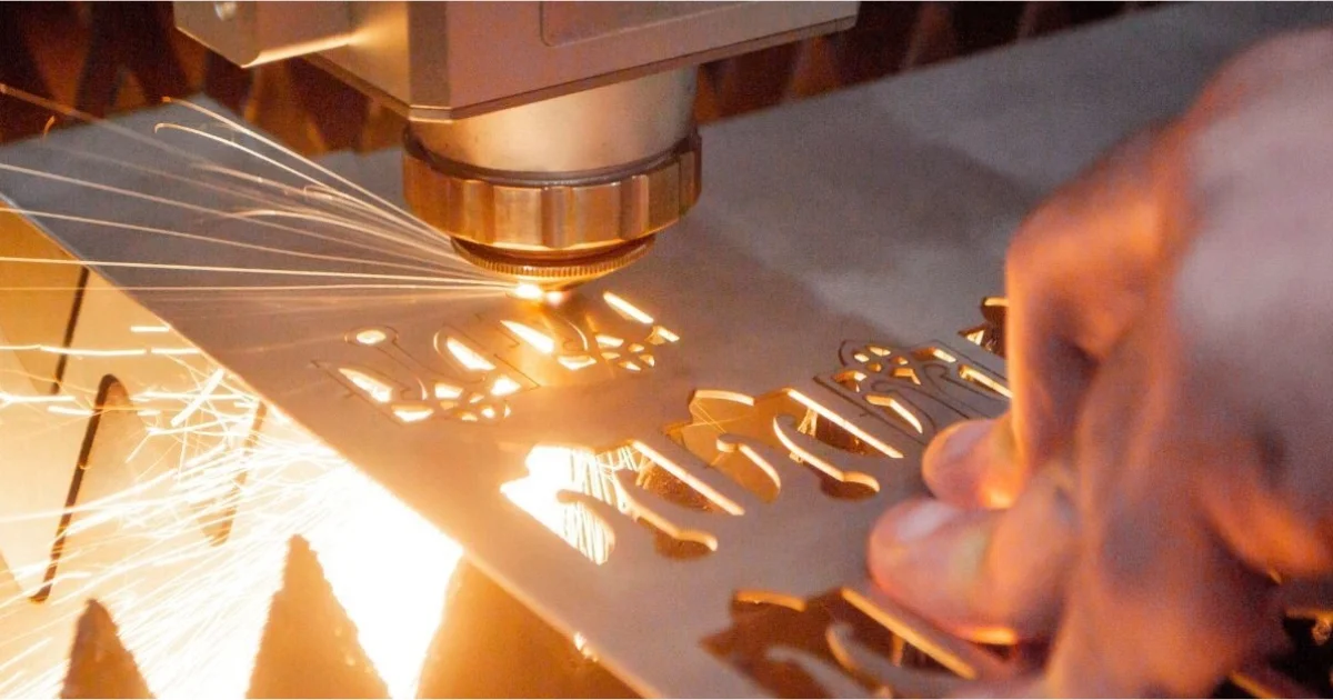 laser cutting machine cutting small detailed shapes out of a metal sheet